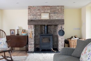 Woodburning stove set within brick chimney breast