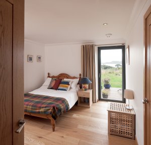 Neutral bedroom with wood flooring