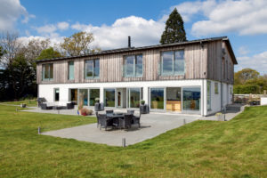 Wood-clad package home with timber frame