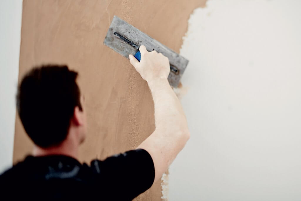 Tradesman applying British Gypsum finishing plaster