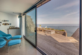 Sliding glazing doors by IDSystems opening up to a wooden deck