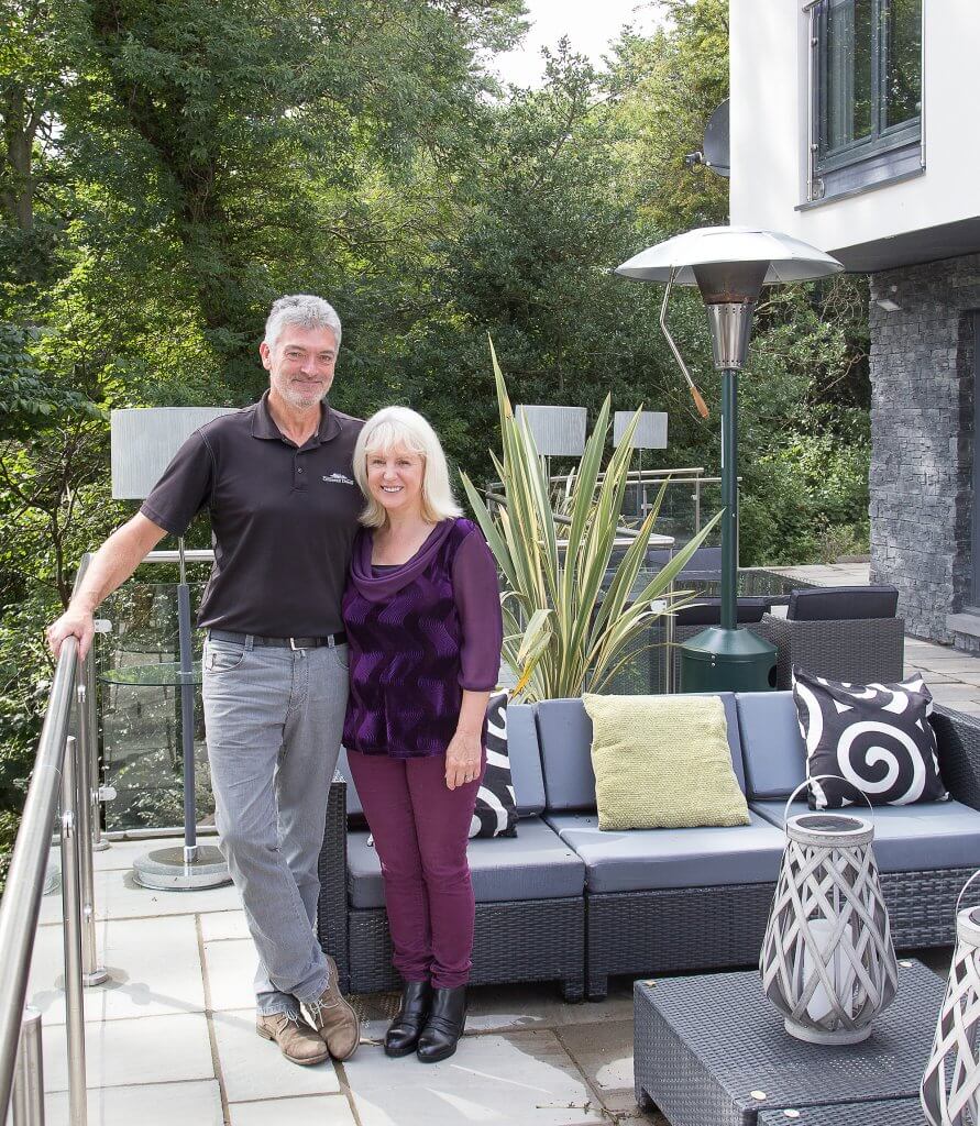 Andrew and June posing outside their home