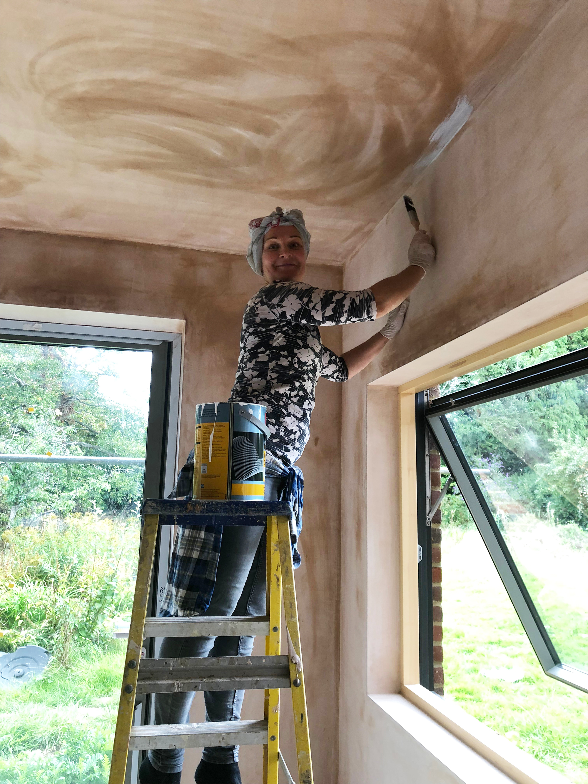 Georgia Betts painting the kitchen