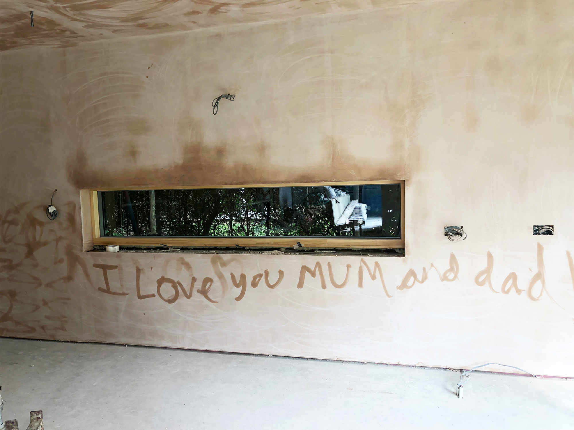I love you mum written on plastered walls