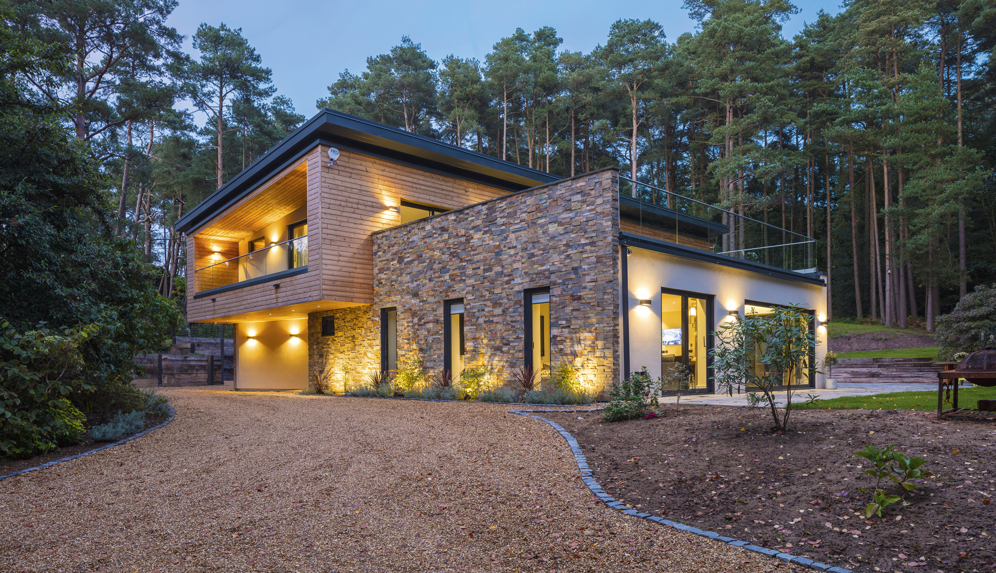 Fully integrated smart home as seen from outside clad in stone and timber