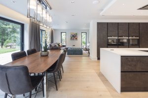 Dining room next to kitchen island in fully integrated smart home