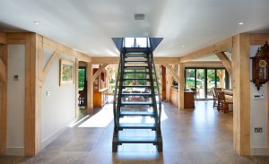 Modern staircase in oak frame home