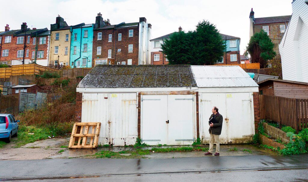 Planning consultant looks at site with garages