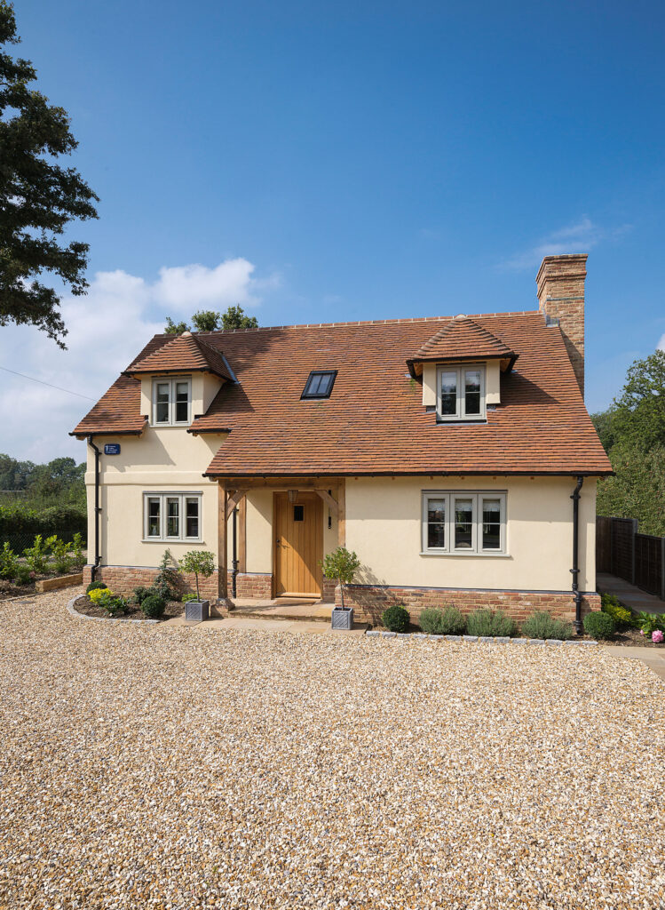 Oak frame home with gravel driveway