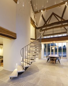Staircase wrapped around pillar in barn conversion by Studio Mark Ruthven