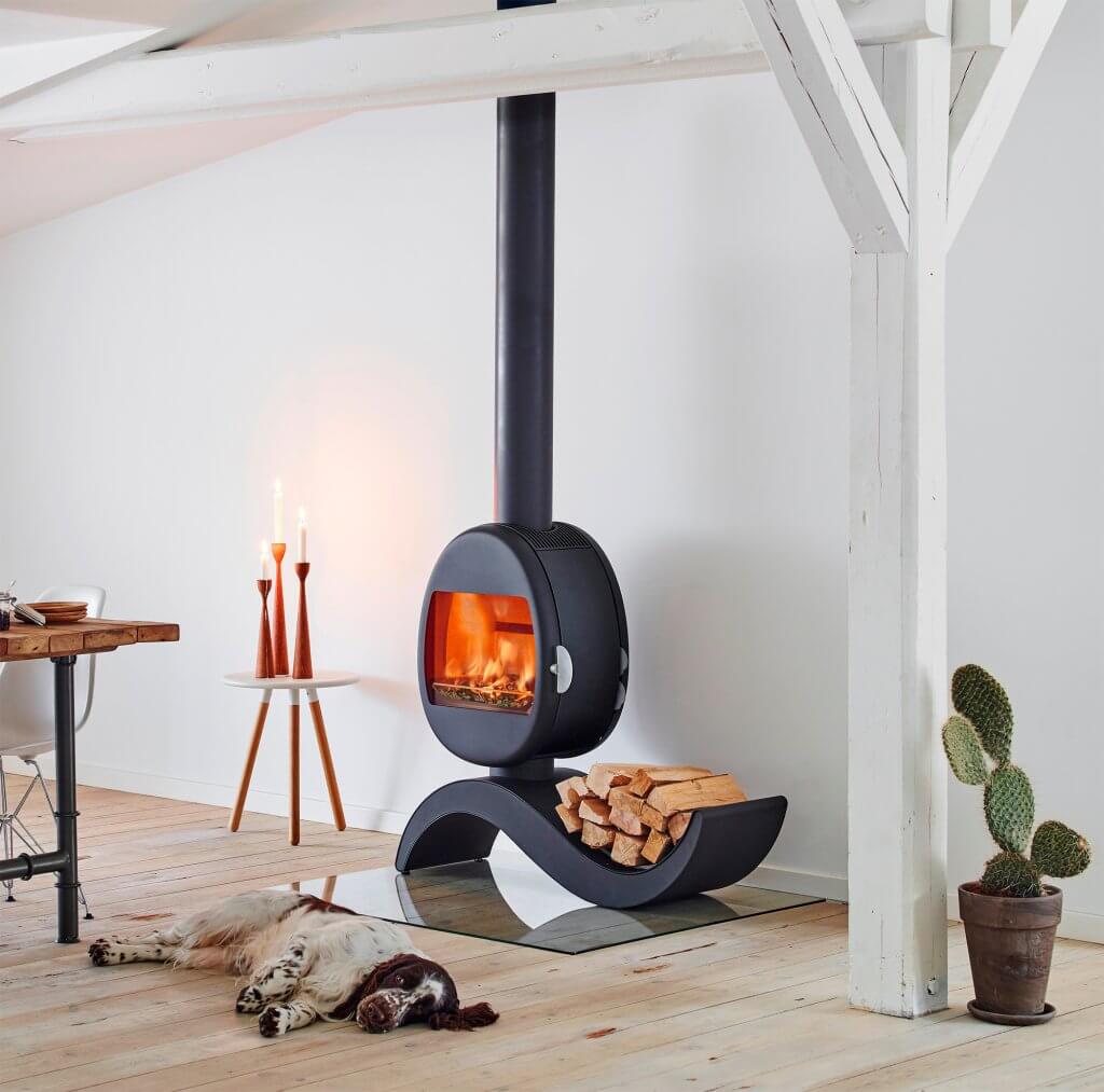 Dog resting in front of a woodburning stove