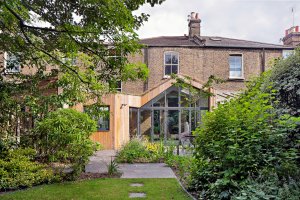 Timber clad extension to Victorian terrace with glazed gable