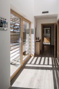 Corridor with sliding doors in timber frame home