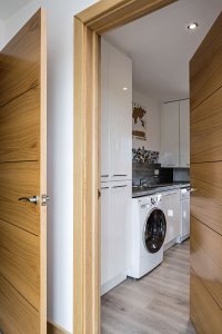 Utility room with washing machine in timber frame home