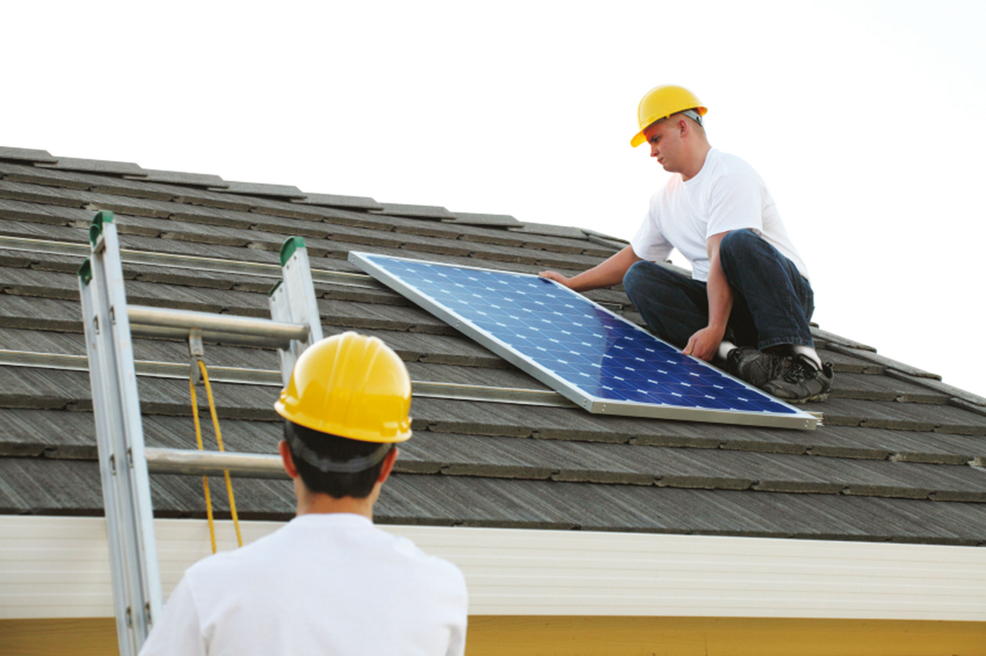 Roofers installing solar panels
