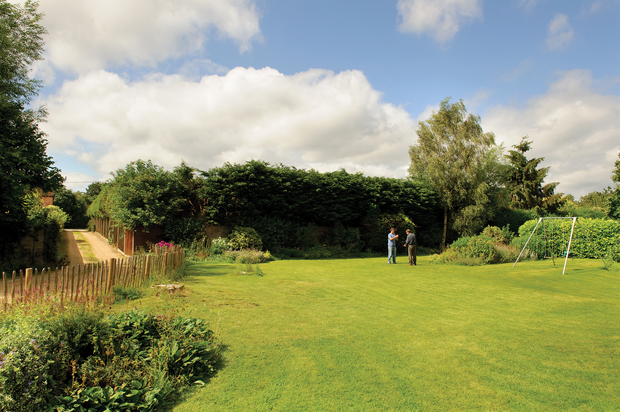 Mike Dade and homeowner looking at the plot