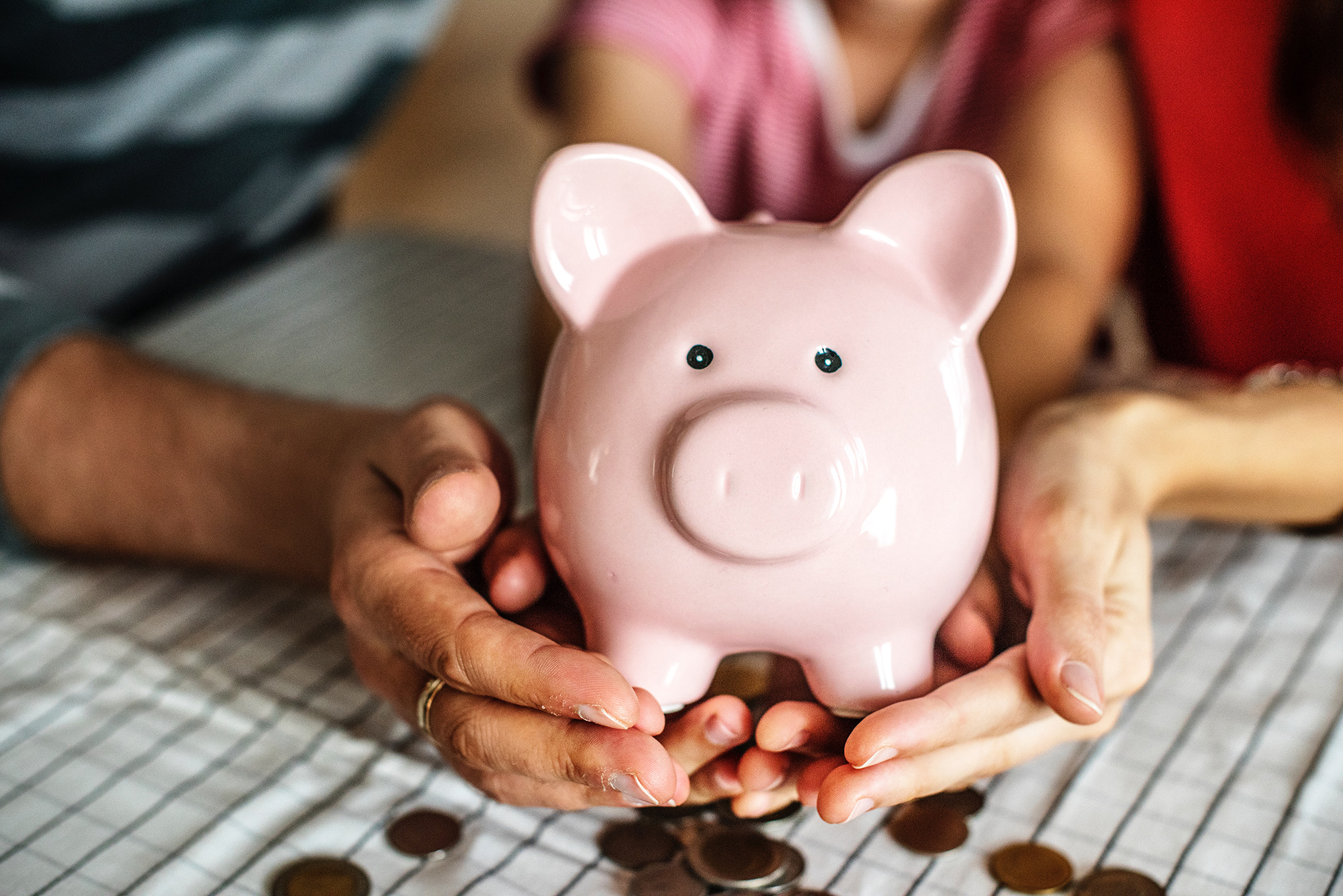 Hands holding a piggy bank