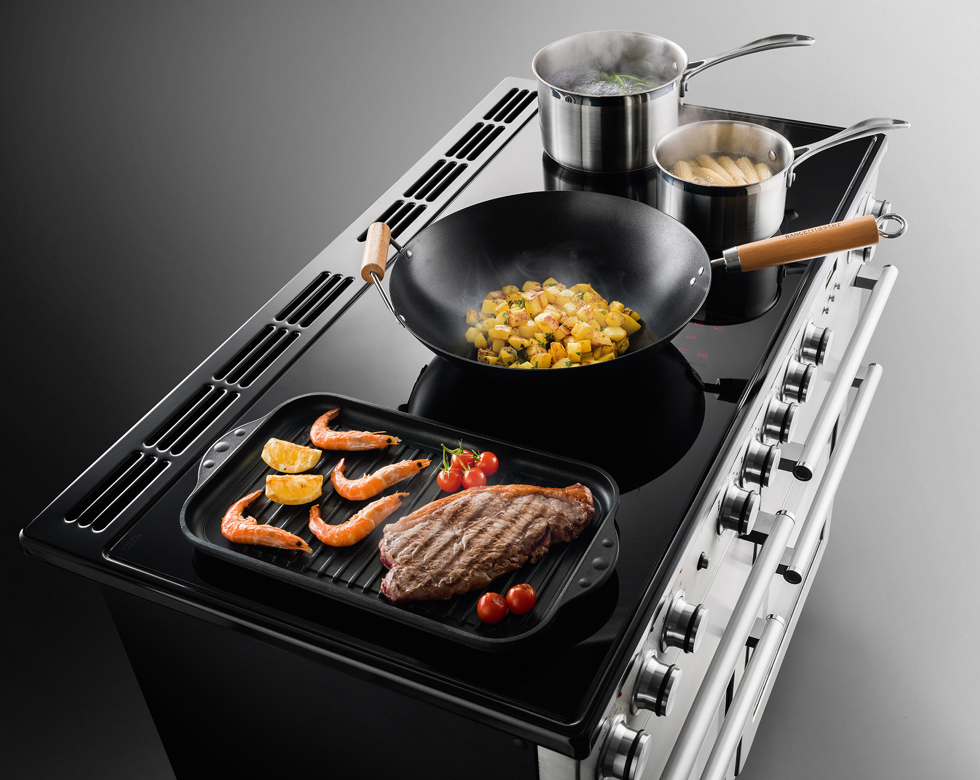 Induction hobs cooking various foods at the same time
