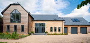 Timber frame home clad in timber and brick