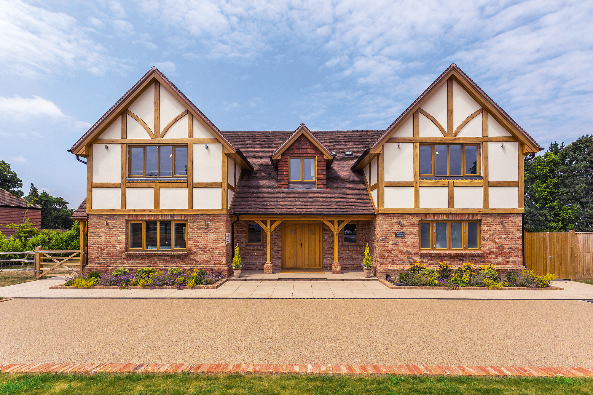 Timber frame home clad in render and brick