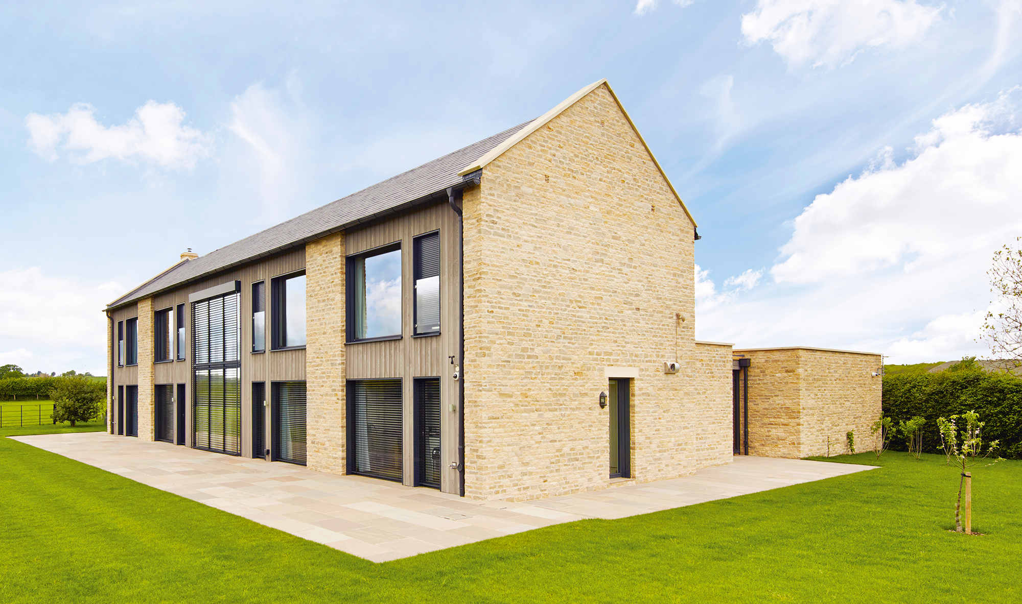 Timber frame home clad in brick and timber