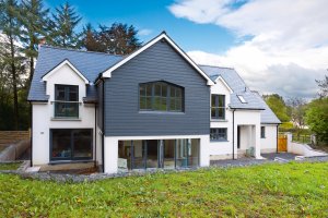 Timber frame home clad in weatherboarding and render