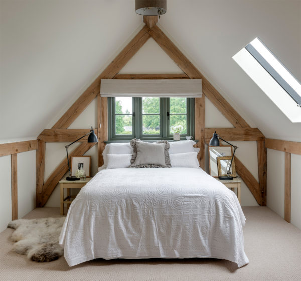 Bedroom in oak frame home with vaulted ceilings