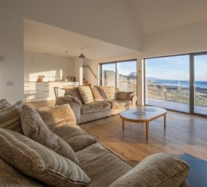 Living room with sliding doors and ample glazing on Scotland's Isle of Skye