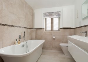 Bathroom in barn style home by Potton