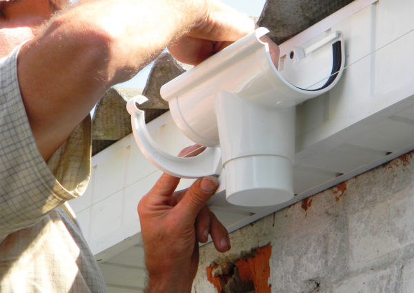 Man installing guttering