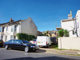 Urban plot at end of terraced homes