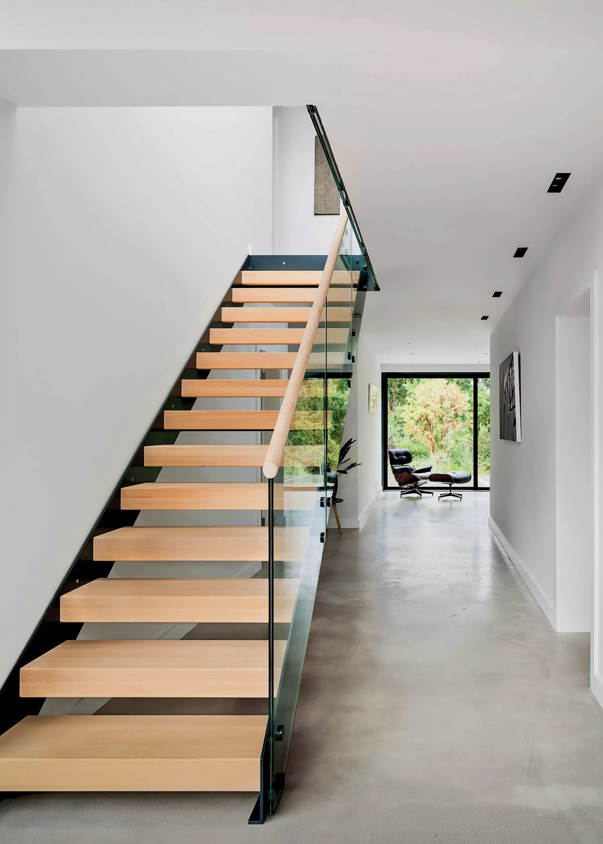 staircase from Complete Stair Systems with solid hardwood treads and a glass balustrade