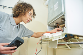 Engineer servicing boiler