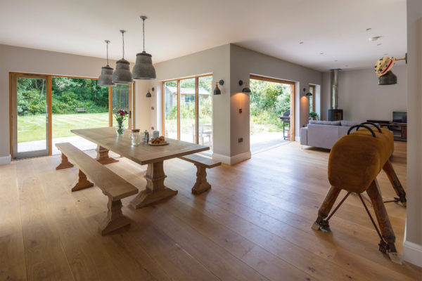 Open plan dining-living room with glazed doors opening to the garden