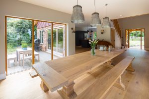 Open plan dining area with large wooden table