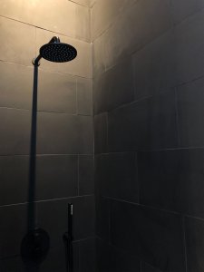 Shower with black tiles