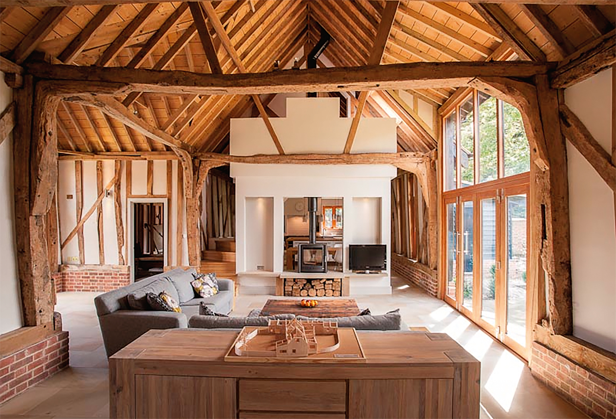 Living space with floor to ceiling windows in barn conversion