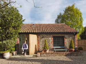 Boathouse conversion as seen from outside with timber door