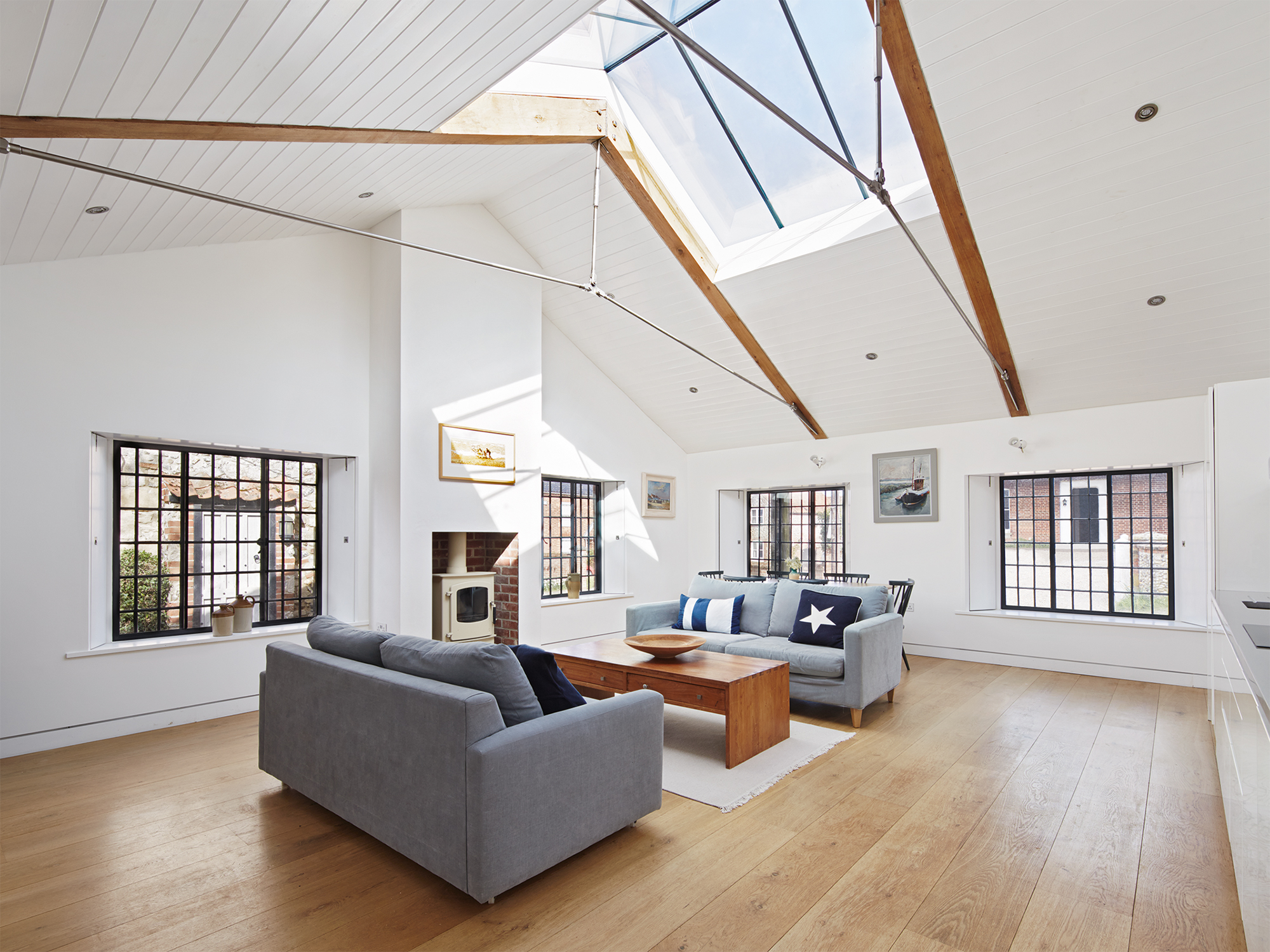 Living room of converted boathouse with large skylight