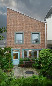 Rear of arts and crafts brick home in London