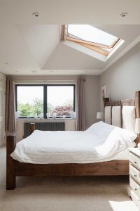 Bedroom with large skylight above bed