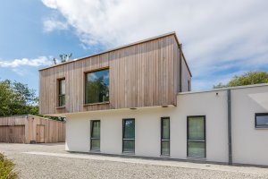 Contemporary home clad in timber and render