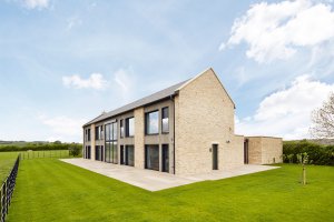 Modern energy efficient home manufactured offsite clad in stone