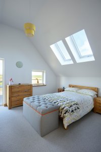 Bedrooom with rooflights above bed