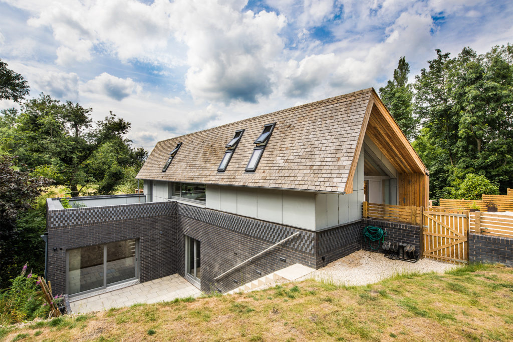 Contemporary timber frame home on sloping site by Frame Technologies