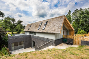 Contemporary timber frame home on sloping site by Frame Technologies