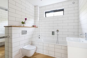 Tiled bathroom with floating toilet