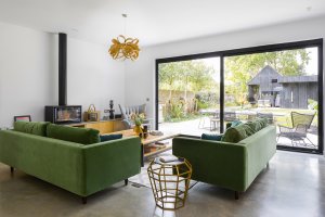 Open plan sitting room with velvet sofas