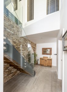 Glass staircase in contemporary hallway