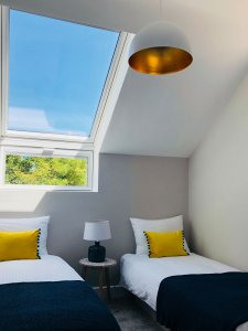 Modern twin bedroom renovation with skylight
